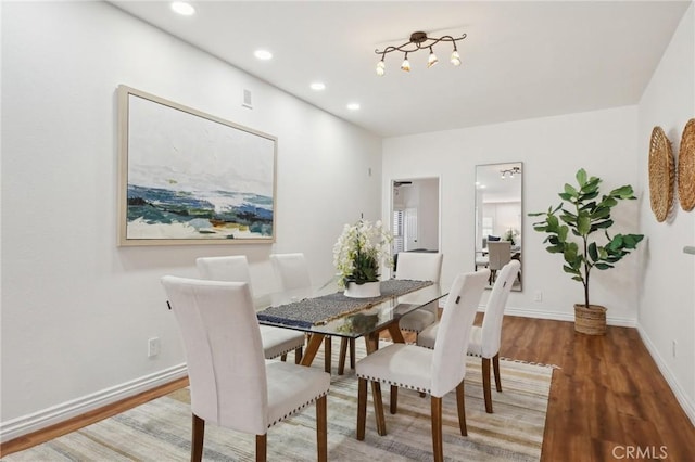 dining area featuring recessed lighting, baseboards, and wood finished floors