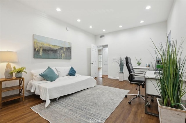 bedroom featuring baseboards, visible vents, wood finished floors, and recessed lighting