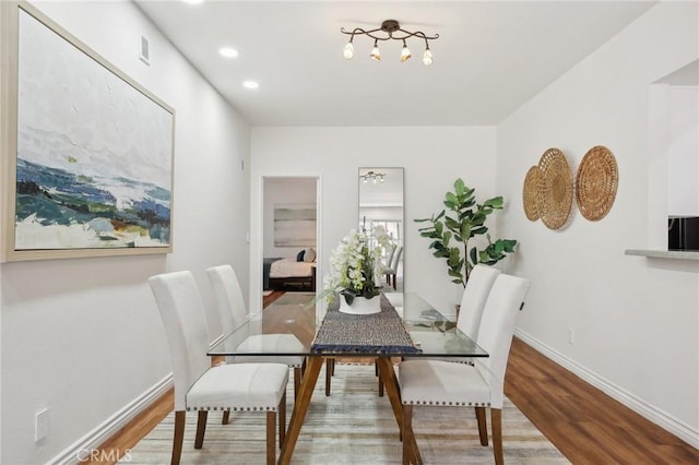 dining room featuring recessed lighting, baseboards, and wood finished floors