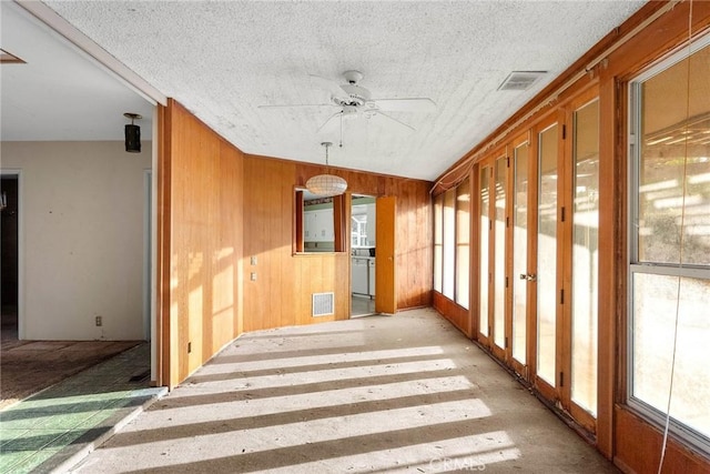 interior space with visible vents and a ceiling fan