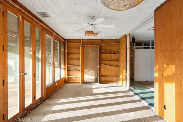 hallway featuring a textured ceiling and visible vents