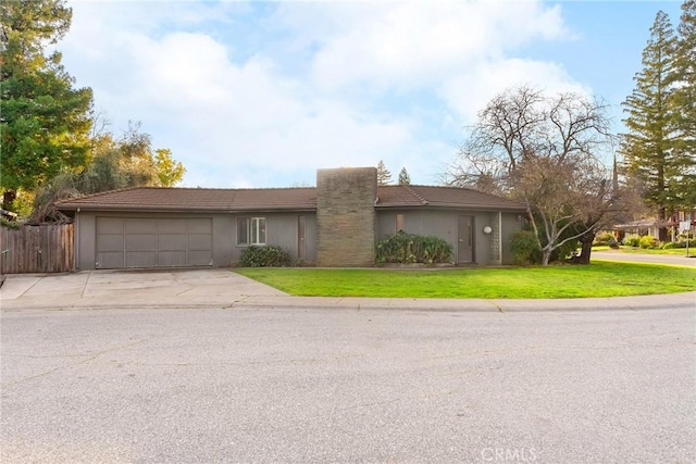 ranch-style house with an attached garage, fence, driveway, stucco siding, and a front yard