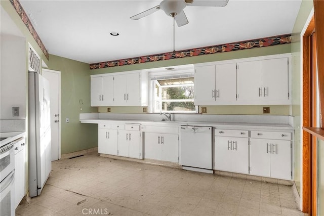 kitchen featuring white cabinets, white appliances, light countertops, and light floors