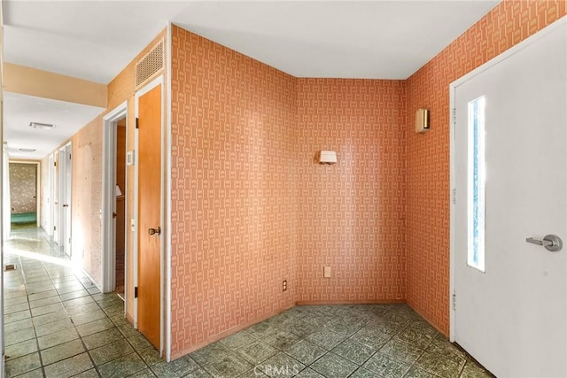 entrance foyer featuring wallpapered walls