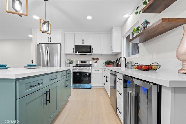 kitchen with beverage cooler, appliances with stainless steel finishes, white cabinetry, and open shelves