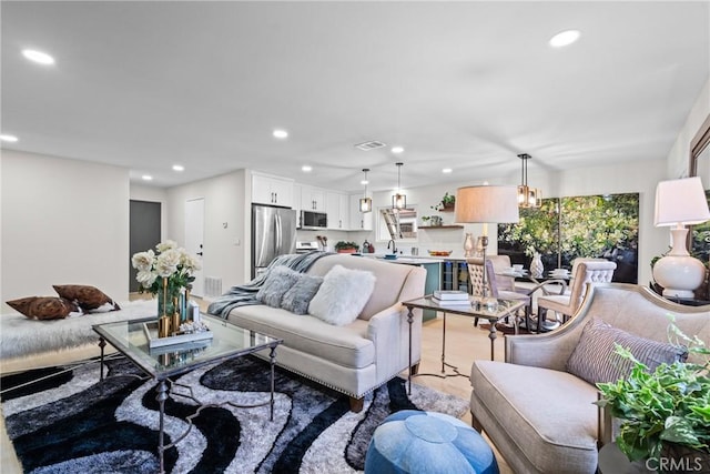 living room featuring recessed lighting and visible vents