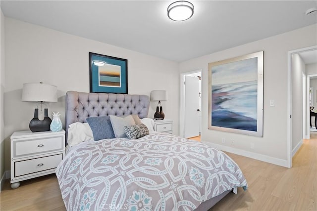 bedroom featuring baseboards and wood finished floors