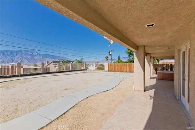 view of patio with a fenced backyard and a mountain view