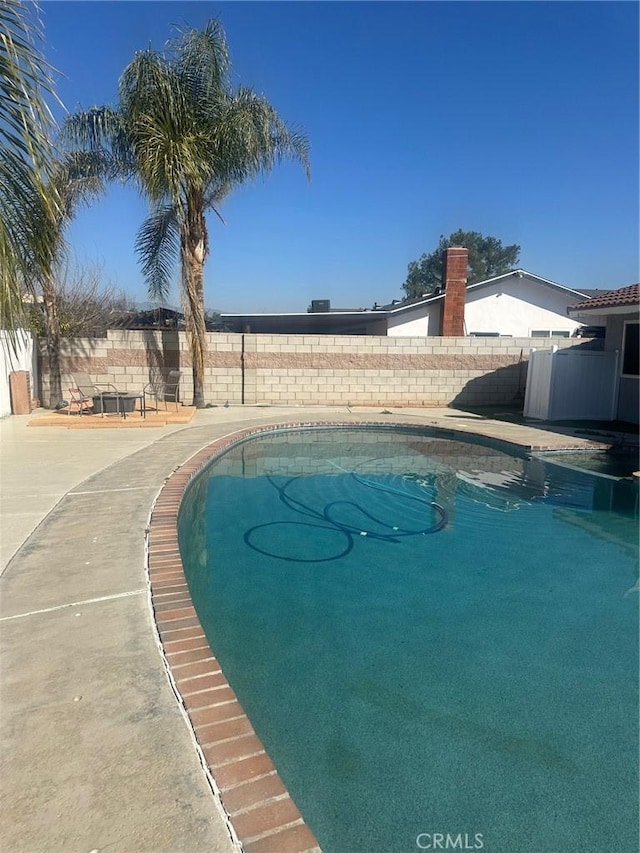 view of pool with a fenced in pool and fence