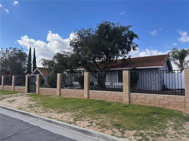 view of front of property with a fenced front yard and a gate