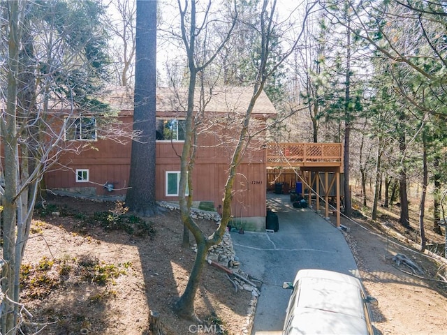 view of property exterior with a wooden deck