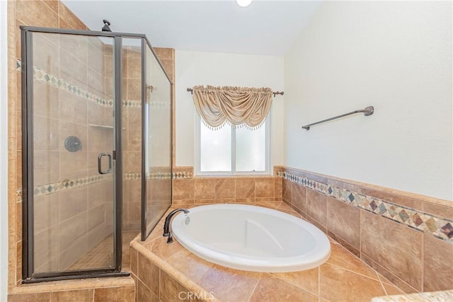 bathroom featuring a stall shower and a garden tub