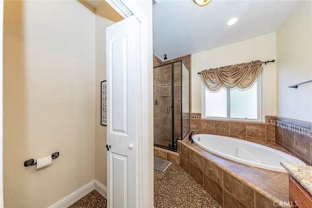 bathroom with a stall shower, a bath, and baseboards