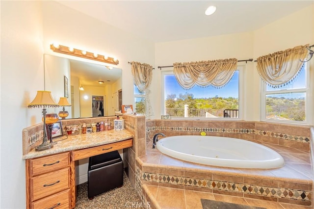 full bath featuring a whirlpool tub and vanity