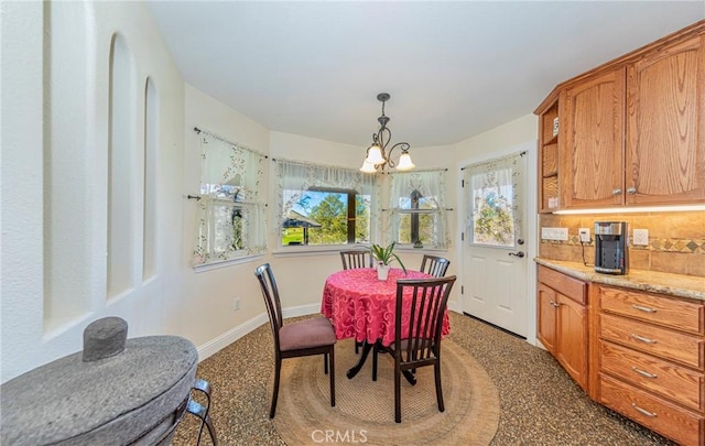 dining space featuring an inviting chandelier, plenty of natural light, and baseboards