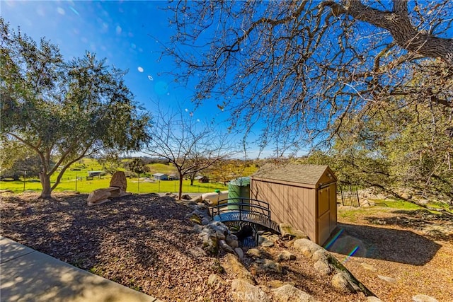 view of yard featuring an outbuilding and a shed