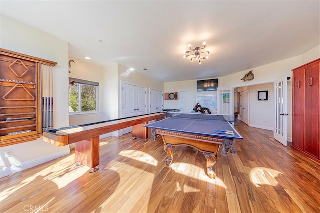 rec room with wood finished floors and baseboards