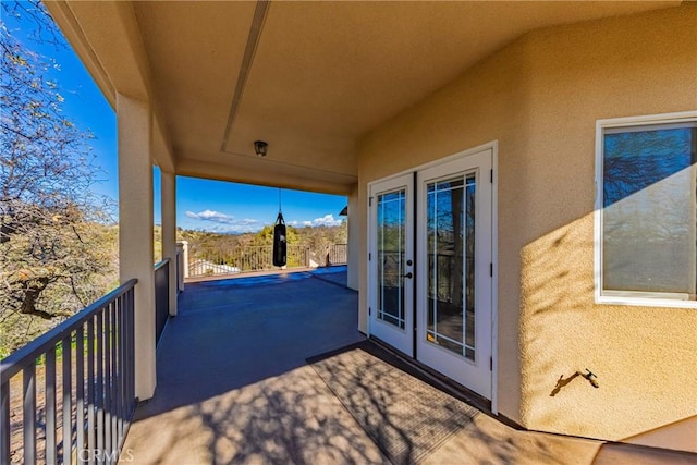 view of patio featuring french doors and a balcony