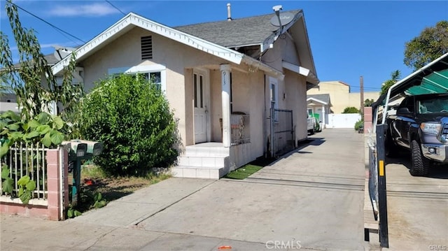 view of home's exterior with fence and stucco siding