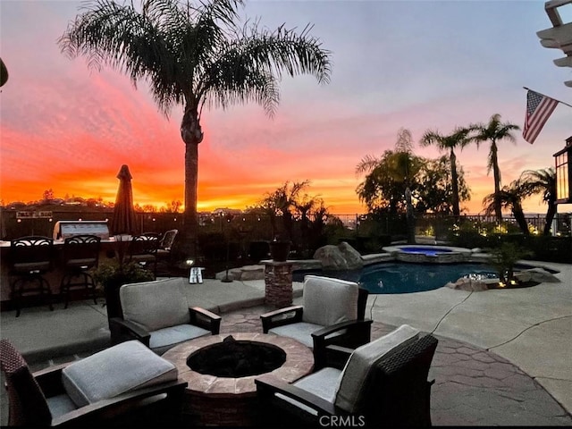 pool at dusk featuring an outdoor fire pit, an outdoor pool, a patio, and an in ground hot tub