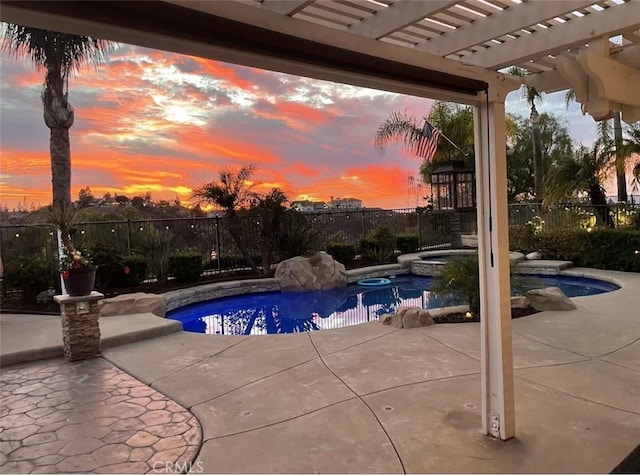 pool at dusk featuring a patio, an in ground hot tub, fence, a fenced in pool, and a pergola