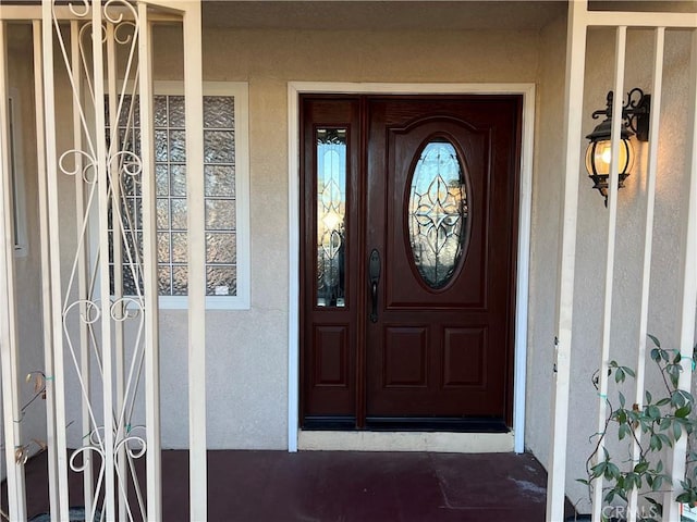 property entrance with stucco siding