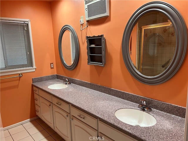 full bathroom featuring double vanity, tiled shower, tile patterned flooring, and a sink