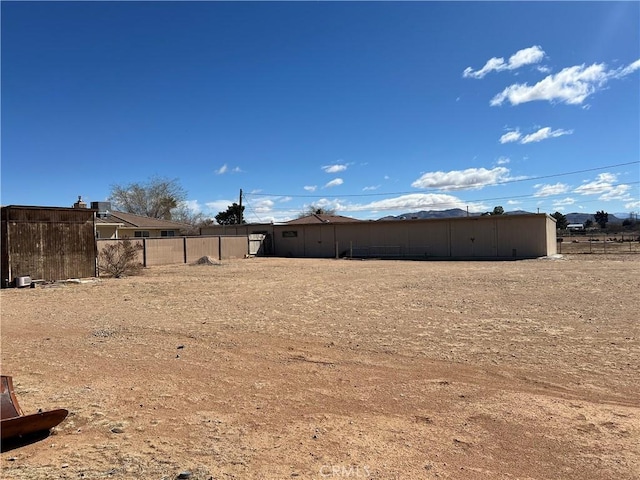 view of yard featuring fence and an outdoor structure