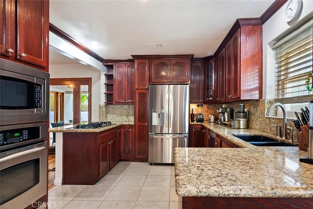 4816 Atoll Ave, Sherman Oaks, CA 91423 - kitchen featuring appliances with stainless steel finishes, dark brown cabinets, and light stone counters