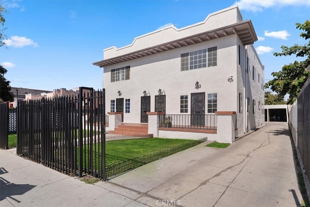 view of front of property with a fenced front yard and stucco siding