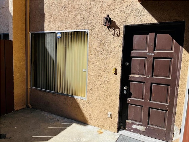 doorway to property with stucco siding