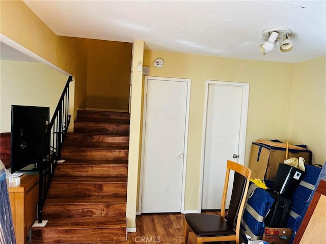 stairs featuring wood finished floors