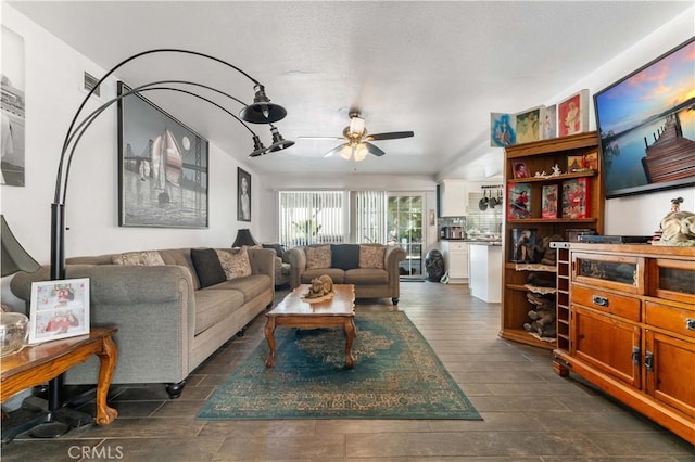 living area with a ceiling fan and dark wood-type flooring