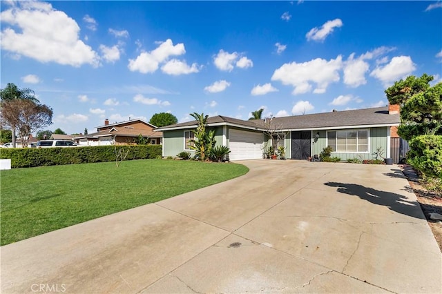 ranch-style home featuring a garage, driveway, and a front lawn