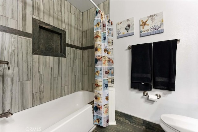 bathroom with shower / bath combo with shower curtain and toilet