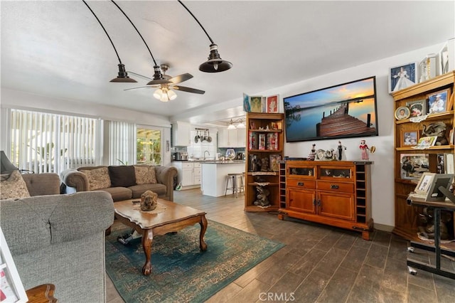 living room featuring dark wood finished floors and ceiling fan