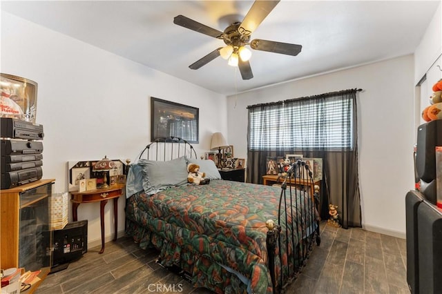 bedroom with wood finish floors, a ceiling fan, and baseboards