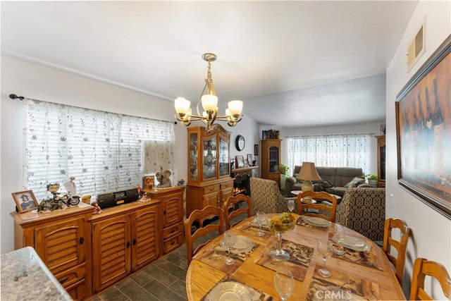 dining space with visible vents and a notable chandelier