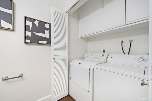 clothes washing area with separate washer and dryer, cabinet space, and baseboards