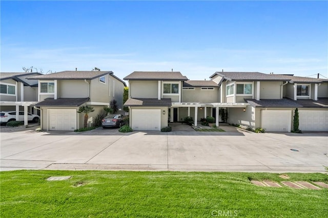 view of front facade featuring concrete driveway, an attached garage, and a residential view