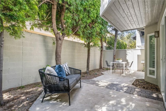 view of patio with outdoor dining space, a fenced backyard, and outdoor lounge area