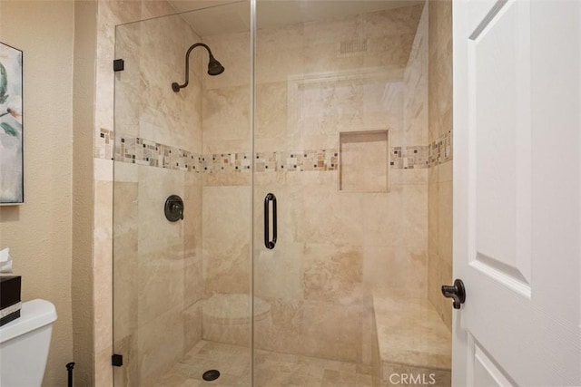 full bath with toilet and a shower stall