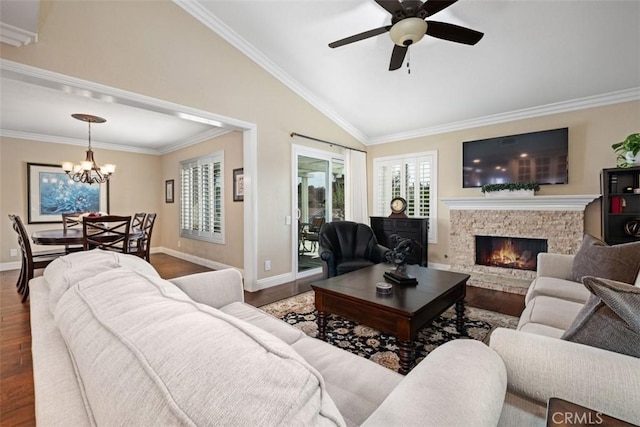 living area featuring crown molding, vaulted ceiling, and wood finished floors