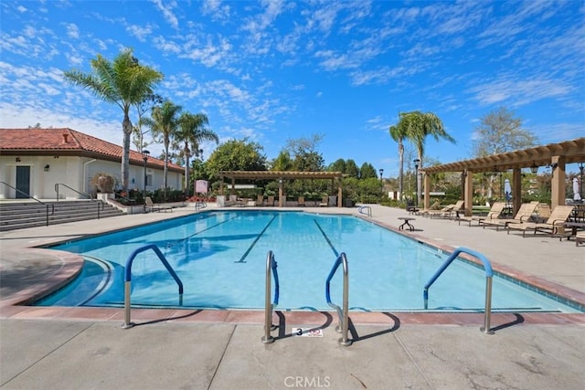 pool featuring a patio and a pergola