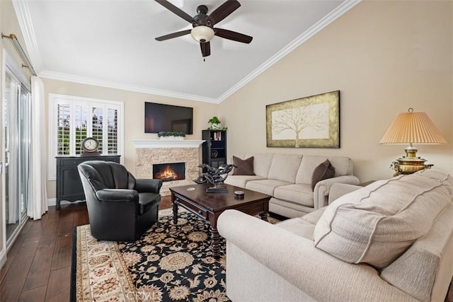 living room featuring lofted ceiling, ornamental molding, a fireplace, and dark wood finished floors