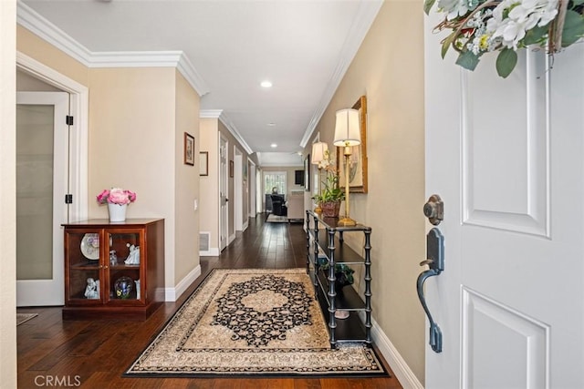 entryway featuring dark wood-style floors, visible vents, crown molding, and baseboards