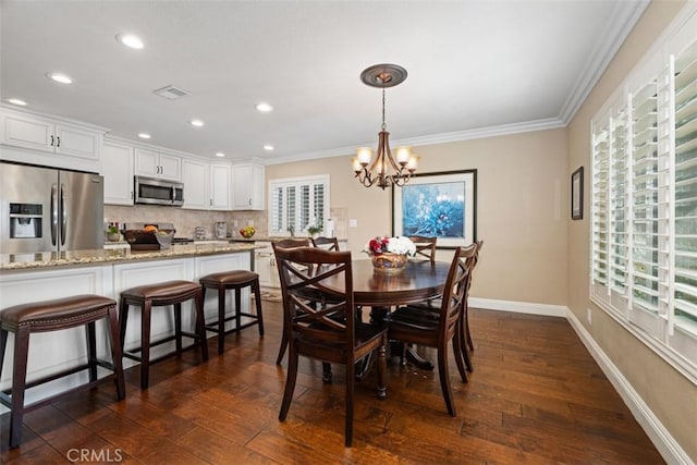 dining room with dark wood-style floors, ornamental molding, and visible vents