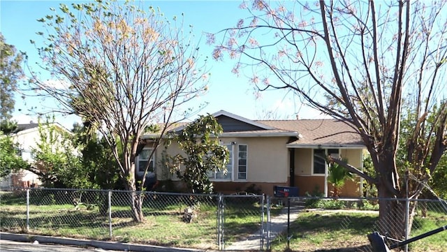 ranch-style house with a fenced front yard and stucco siding