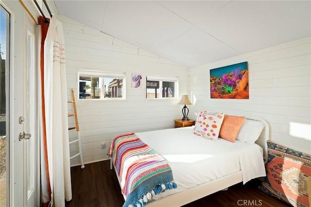 bedroom featuring lofted ceiling and dark wood finished floors