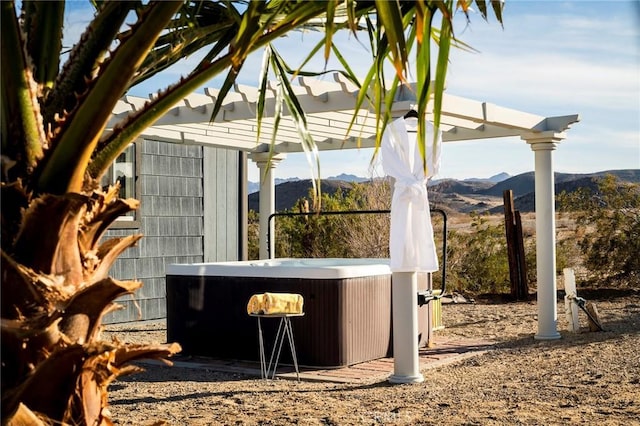 exterior space featuring a mountain view and a hot tub